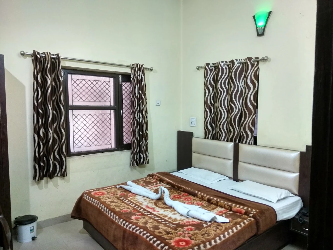 Double bed room with curtains and attached room facilities